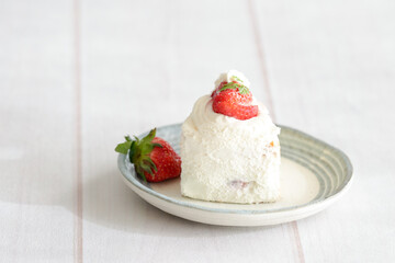 Japanese shortcake with strawberries on top is placed on a white wooden floor