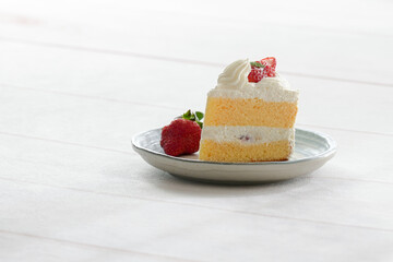 Japanese shortcake with strawberries on top is placed on a white wooden floor