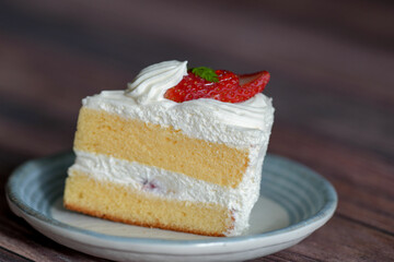 Japanese shortcake with strawberries on top is placed on wooden floor