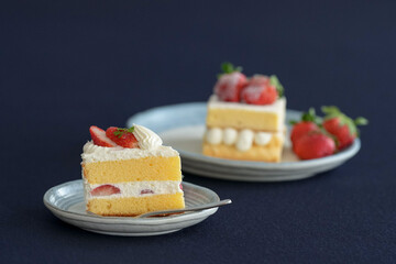 Japanese shortcake with strawberries on top is placed on a black cloth
