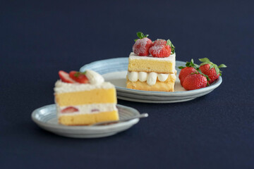 Japanese shortcake with strawberries on top is placed on a black cloth