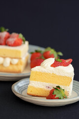 Japanese shortcake with strawberries on top is placed on a black cloth