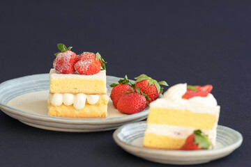 Japanese shortcake with strawberries on top is placed on a black cloth