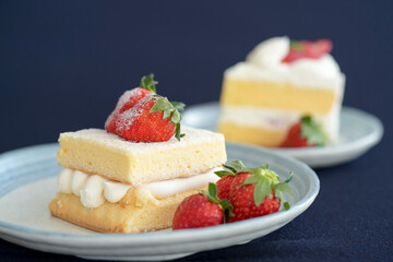 Japanese shortcake with strawberries on top is placed on a black cloth