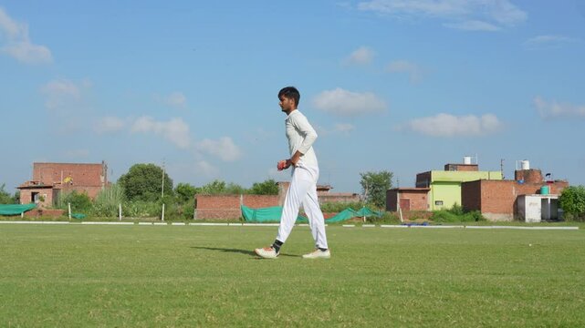 A bowler delivering a fast ball during a cricket game