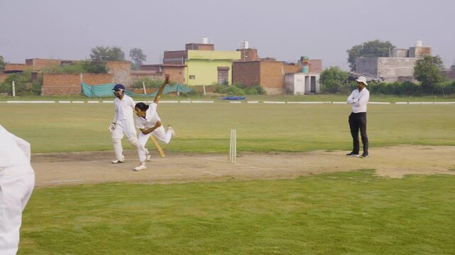 A bowler delivering a fast ball during a cricket game