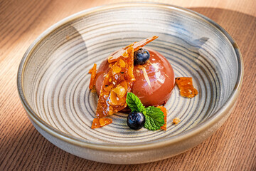 chocolate pastry with caramel and blueberries