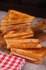 Fresh Ham and Cheese Sandwiches Stacked on a Dark Concrete Table