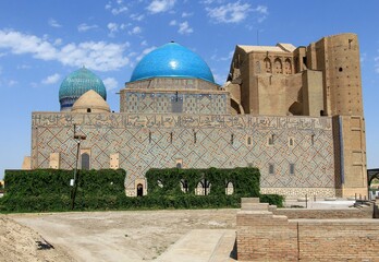 Fototapeta premium Ahmet Yesevi Tomb was built by Timur in 1389. The entrance gate and garden of the social complex. Arabic verses are written on the bottom of the dome.
