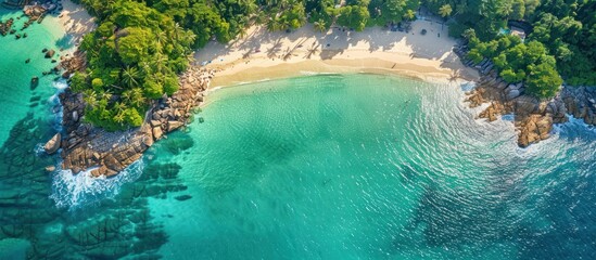 Obraz premium Aerial View of a Tropical Beach with Clear Turquoise Waters