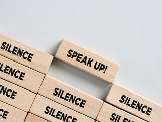 Breaking the silence: speak up concept with wooden blocks