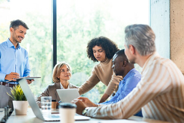 Business team discussing together business plans in office.