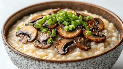 Close-up of a bowl of creamy mushroom risotto garnished with fresh green onions.