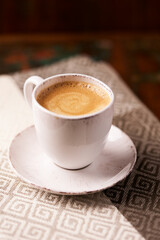 Cup of coffee on wooden background. Soft focus
