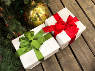 Two white and red boxes with green ribbons on them