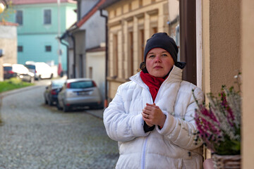 Fototapeta premium A plus-size woman strolling through the streets of a small European town.