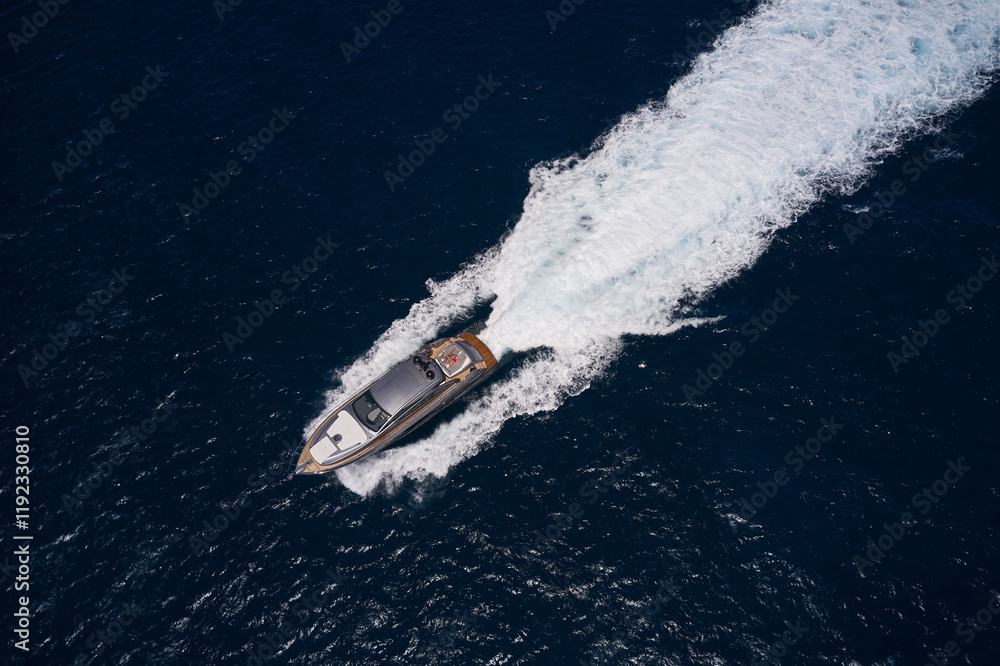 Poster Luxury big yacht gray color with man and woman view from above fast movements in open sea. Expensive yacht gray color on background dark blue sea, fast movement on dark water.