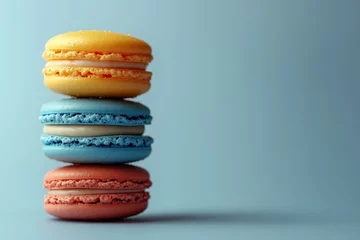 Poster Stack of colorful macarons on a blue background