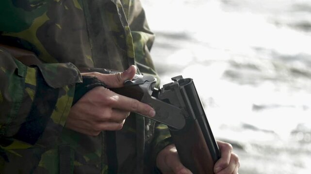Closeup slow motion footage of the shotgun shells leaving barrel in smoke while hunting