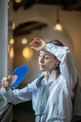 Woman, tired of stuffiness at work, suffering from heat or headache, sweltering stuffy air in an...