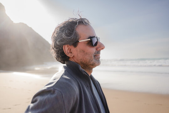 Relaxed Man in Sunglasses Enjoying the Beach at Praia da Adraga