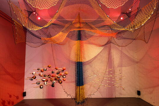  Venice Art Biennale. Pavilion of Brazil. Cardume - School of Fish by Ziel Karapotó, Karapotó Terra Nova Community. Installation of fishig nets, maracás, ammunition rounds