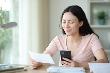 Asian woman paying bill online at home