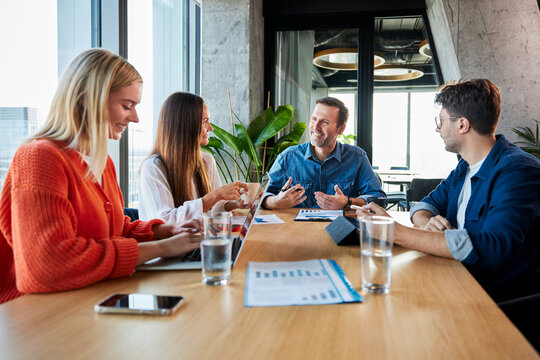 Smiling business colleagues having meeting in conference room at office - Powered by Adobe