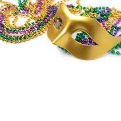Mardi gras beads and mask isolated on white background © Anna