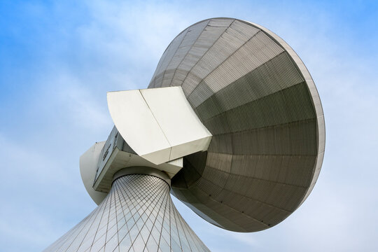 Large satellite dish parabola under blue sky