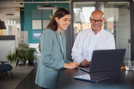 Businessman and woman attending meeting at office