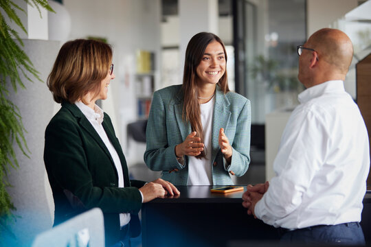 Young woman sharing ideas with colleagues at office