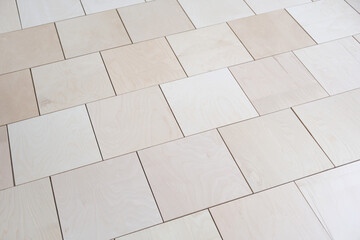 Naklejka premium Plywood sheets on the floor. Professional plywood laying with gaps and displacement. Base for floor coverings, parquet or laminate. Apartment renovation