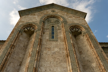 The building has a lot of arches and a window. The arches are very detailed and the window is very...
