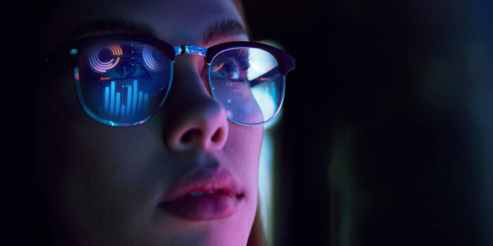 Close-up of businesswoman in glasses reflecting digital graphs, symbolizing data analysis, e-commerce analytics, strategy. Concept of business, modern technologies, finance, investment, digital market - Powered by Adobe