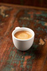Cup of coffee on wooden background. Soft focus.