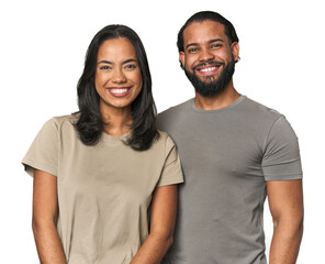 Young Latino couple in studio happy, smiling and cheerful.
