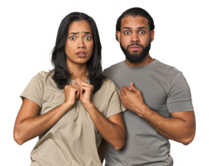 Young Latino couple in studio scared and afraid.