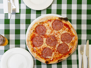 Pepperoni Pizza on Restaurant Plate, Salami Pizza with Olives, Tomatoes and Mozzarella Cheese