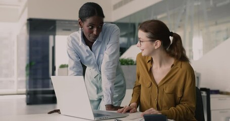 Two women teammates exchange friendly fist bump celebrating successful completion of joint financial task, finalize report, budget planning together in contemporary office. Teamwork, respect, synergy
