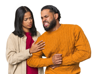 Young Latino couple in studio having a liver pain, stomach ache.