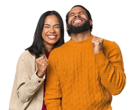 Young Latino couple in studio celebrating a victory, passion and enthusiasm, happy expression.