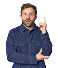 Studio portrait of young Hispanic male having some great idea, concept of creativity.