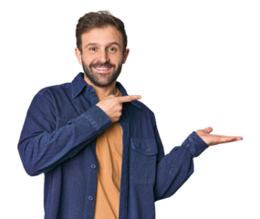 Studio portrait of young Hispanic male excited holding a copy space on palm.