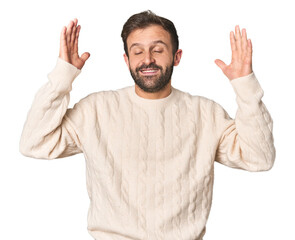 Naklejka premium Studio portrait of young Hispanic male joyful laughing a lot. Happiness concept.