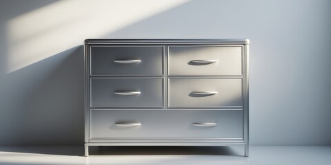A silver metal dresser with four drawers