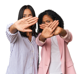 Young Latin businesswomen in studio doing a denial gesture