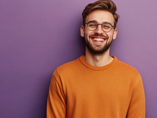 Fototapeta premium Portrait of a smiling man in her 20s standing on a solid color background, luminous, casual cloth