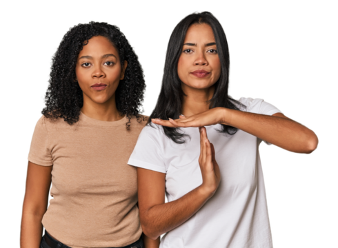 Young Latin friends in studio showing a timeout gesture.