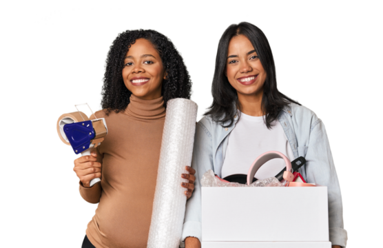 Two Latin women, one pregnant, with moving box in studio